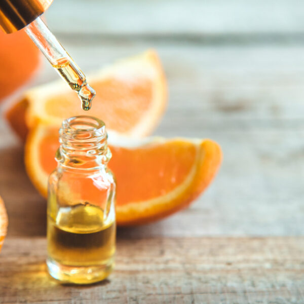 Orange essential oil in a small bottle. Selective focus. Food.